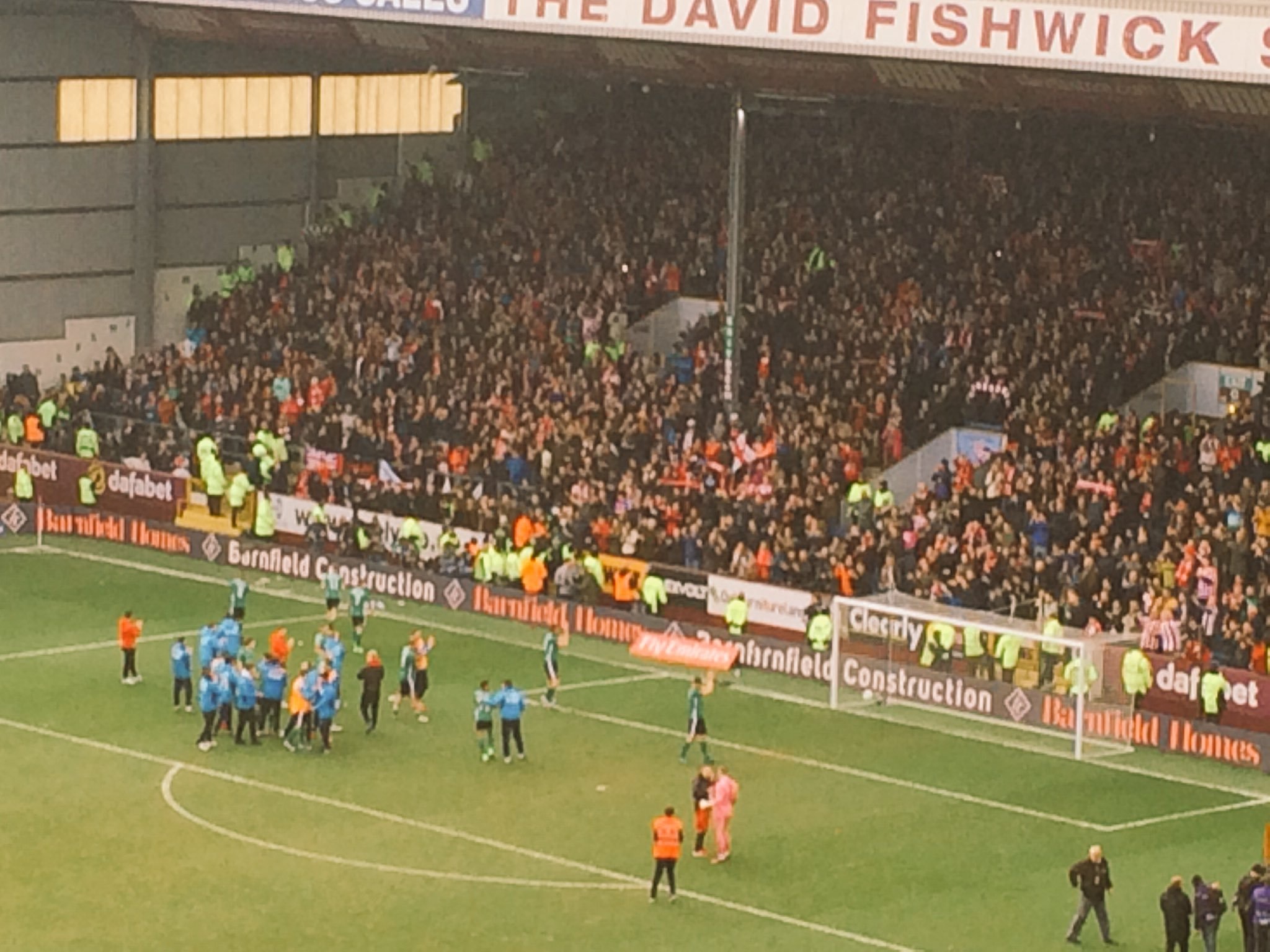 Lincoln's players celebrate with their fans after beating Burnley at Turf Moor. (Photo: James Williams)