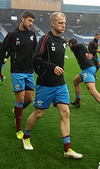 Neal Bishop warming up ahead of his 126th Iron start against Peterborough United.