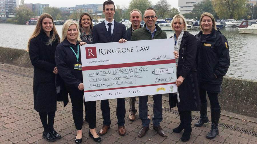 Cheque presented to representatives of the three charities - Credit: Ringrose Law