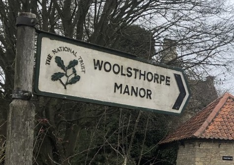 The National Trust sign for Woolsthorpe Manor.
