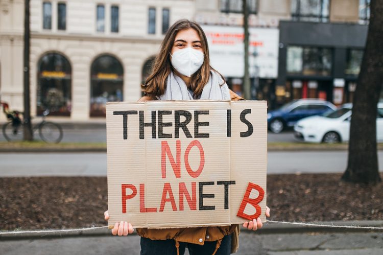 Protester with a sign that reads "There is no Planet B" at a rally against climate change
