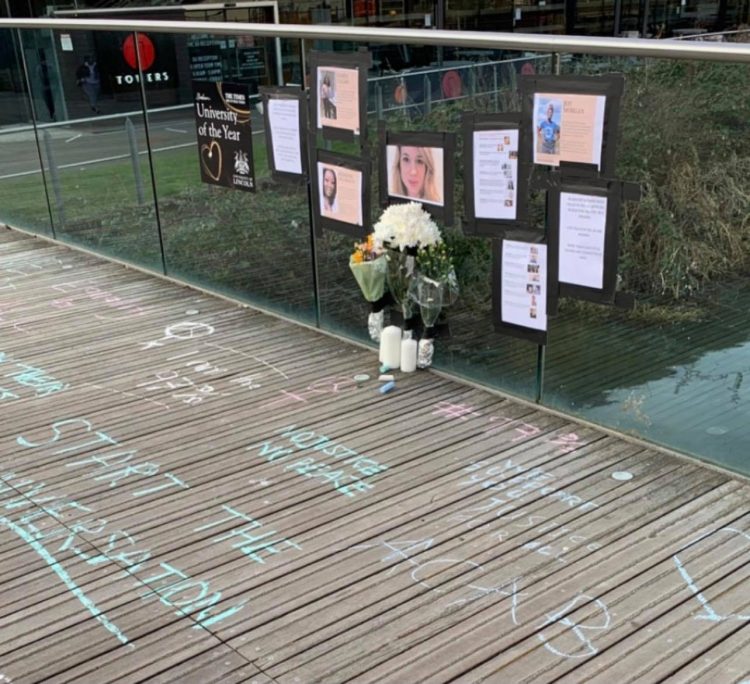 Sarah Everard memorial on University of Lincoln Library Bridge, surrounded by statistics of violence against women.